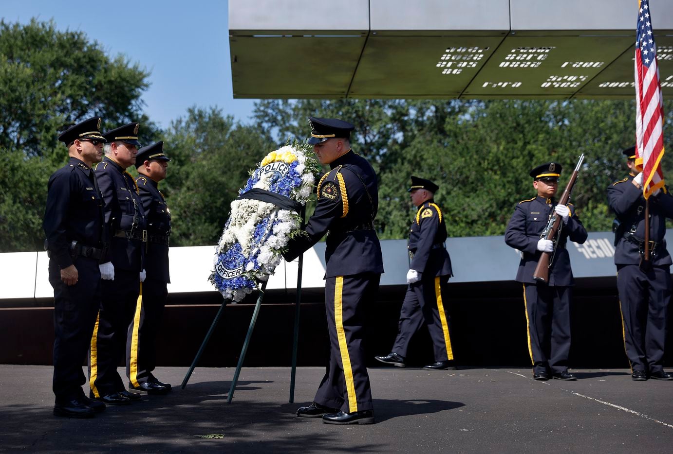 Dallas Police Chief Eddie Garcia (left) receives a wreath he placed in honor of fallen Dallas officers during the 2021 Police Memorial Day at the Dallas Police Memorial in downtown Dallas, Wednesday, July 7, 2021. (Tom Fox/The Dallas Morning News)