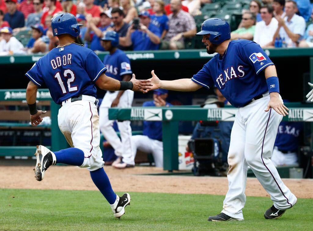 Texas Rangers second baseman Rougned Odor (12) is congratulated after scoring against  the...