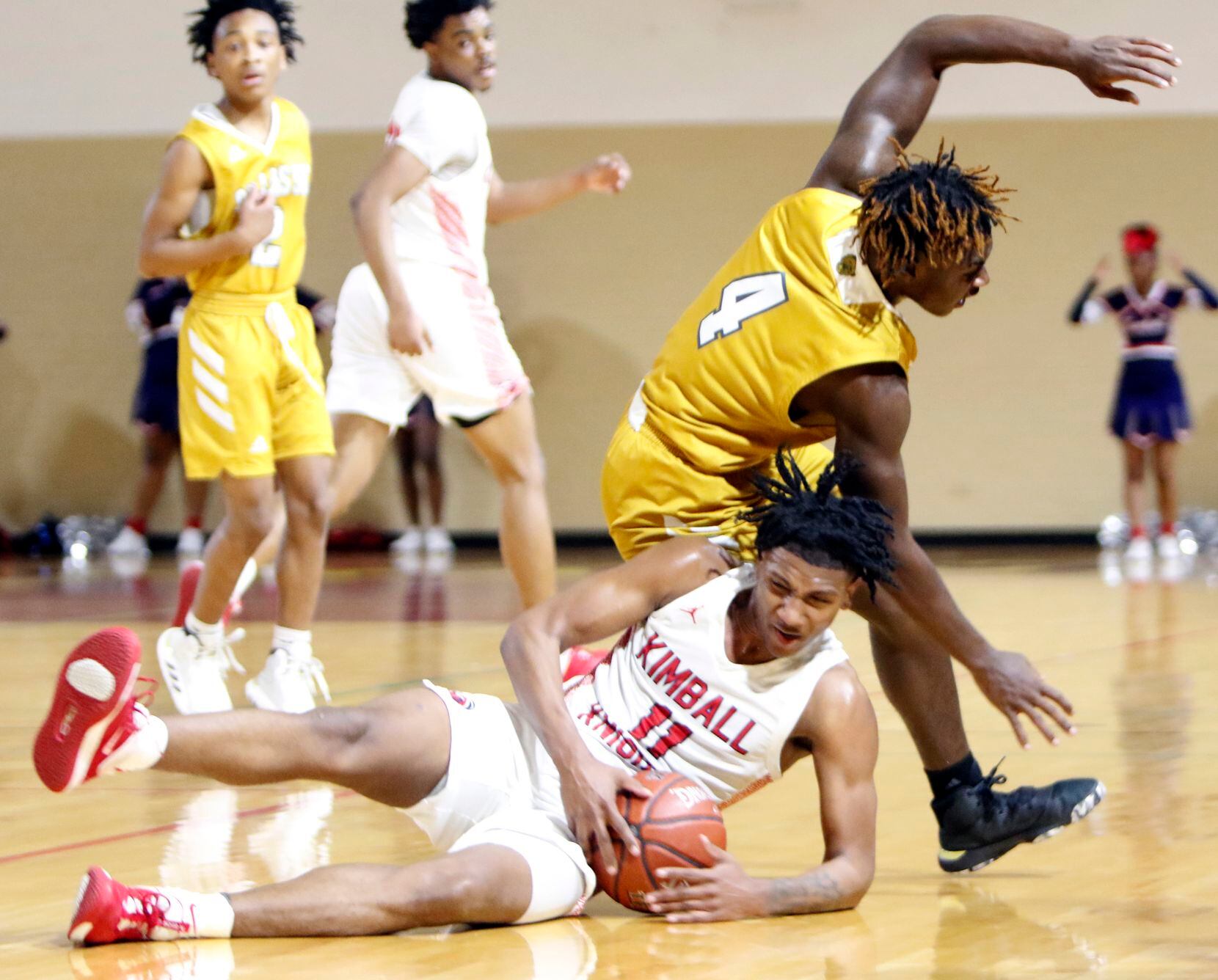 Dallas Kimball guard Cory Reynolds (11) battles for ball possession as South Oak Cliff guard...