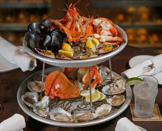 Water Grill's two-tiered deluxe seafood platter, with oysters and clams on the half-shell,...