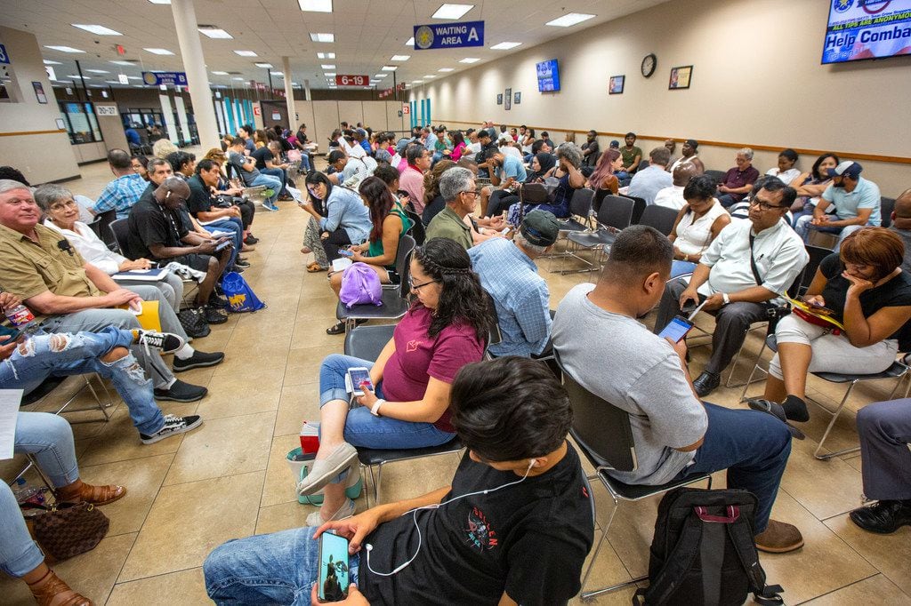 People wait inside a mega center driver license center run by the Texas Department of Public...