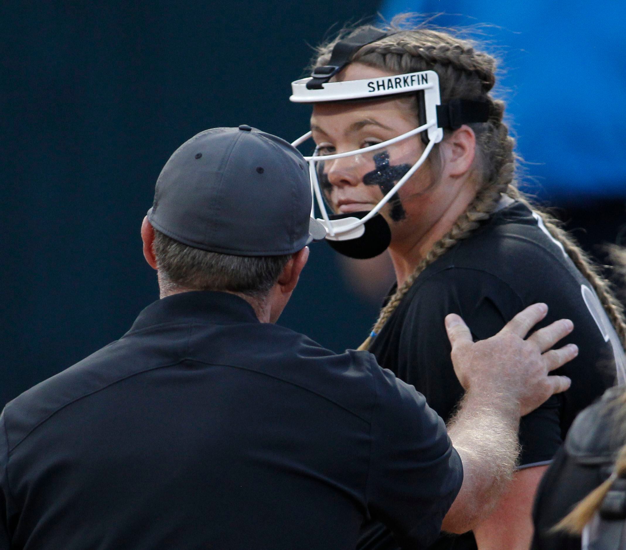 Denton Guyer pitcher Finley Montgomery (20) is relieved of her pitching duties as head coach...