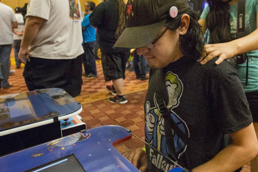 Andrew Anderson plays Space Invaders at the Texas Pinball Festival in Frisco. 