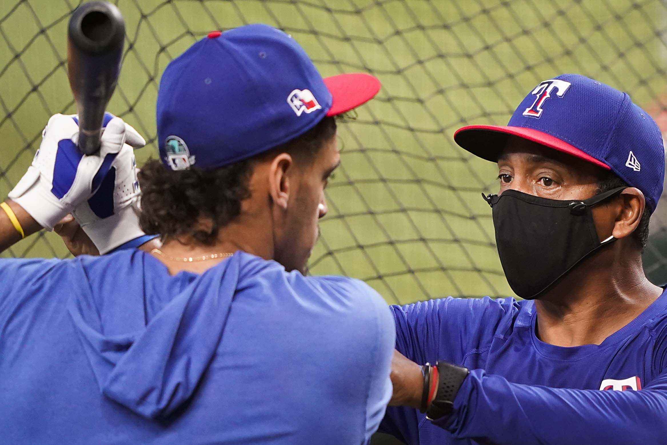 First baseman Ronald Guzman works with hitting coach Luis Ortiz during Texas Rangers Summer...