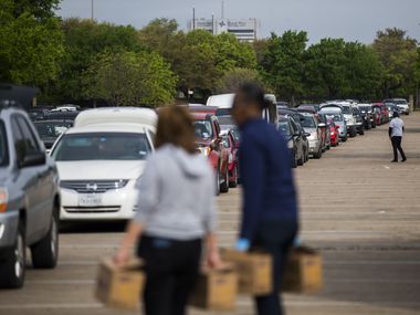 Hundreds of vehicles lined up to receive food during a distribution event put on by the North Texas Food Bank and several partner organizations at Fair Park on Thursday.