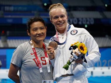USA’s diving coach Jianli You and Krysta Palmer pose for photographers after competing in...