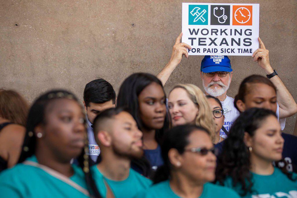 Gene Lantz of the Texas Alliance for Retired Americans holds a sign during a press...