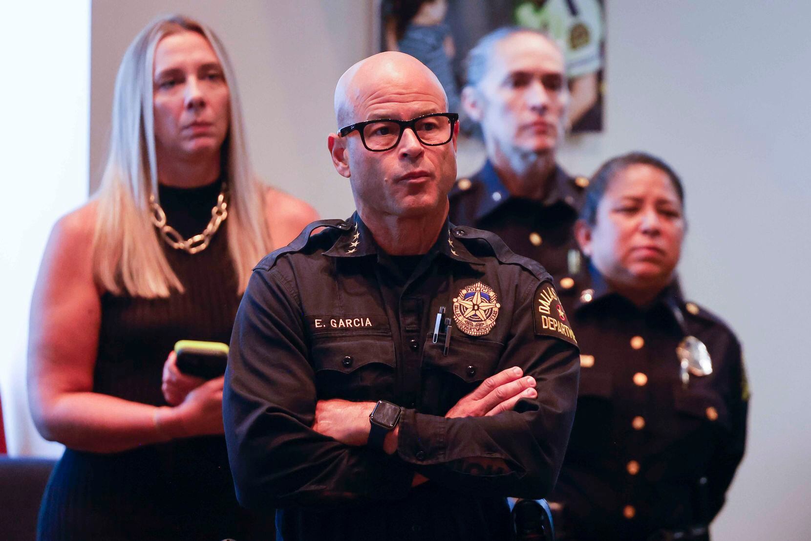 Dallas police Chief Eddie García, center, watches the body-worn camera footage of an officer...