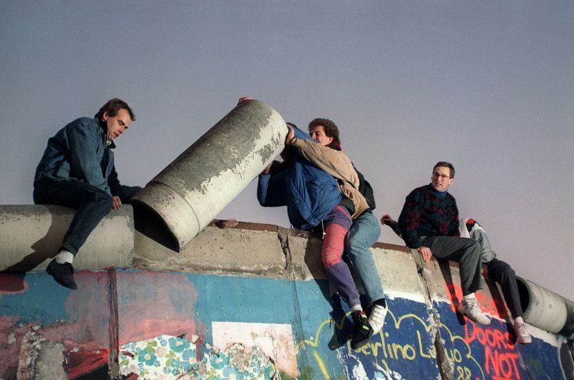  Young West Berliners in November 1989 removed a piece from atop the Berlin Wall.