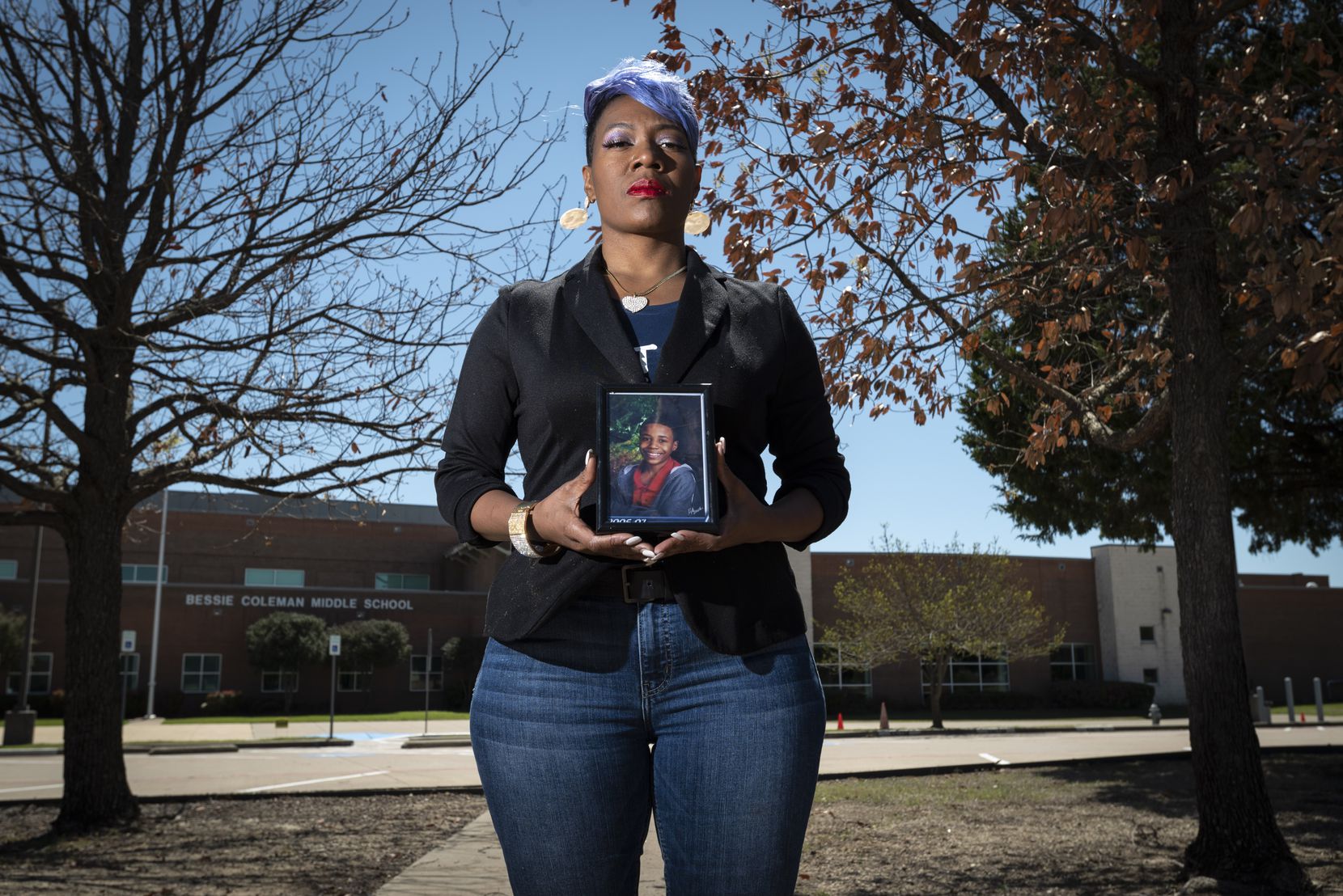 Donna Fields, holding a photo of son Marcus Bell Jr. when he was 12, stands outside Bessie Coleman Middle School in Cedar Hill, which Bell was attending when he says Pastor Rickie Rush sexually assaulted him in Rush’s office at Inspiring Body of Christ Church. “Rush needs to be held accountable,” Bell says. “He doesn’t need to be doing this to anybody else.”