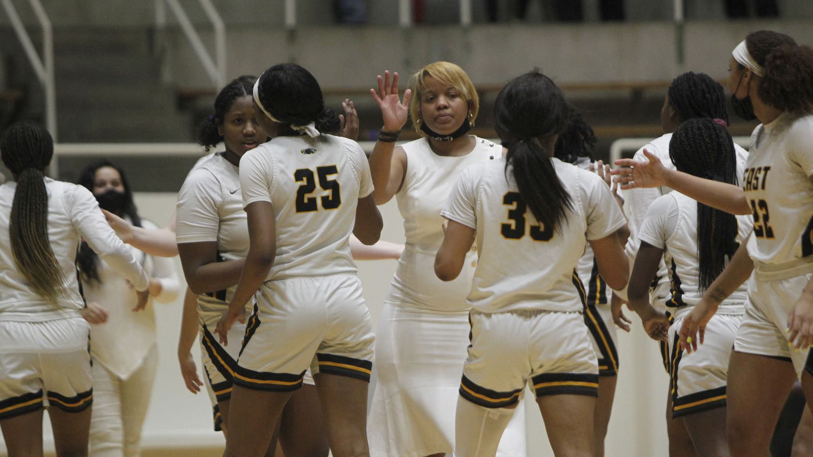 Plano East coach Jessica Linson (center) welcomes her players to the bench area during a timeout in a game against Southlake Carroll on February 27, 2021. (Steve Hamm/Special Contributor)