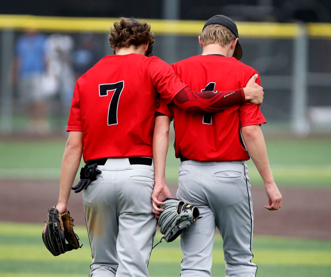 Martin third baseman Max Grubbs (7) consoles pitcher Luke Spencer(1) after he was replaced...