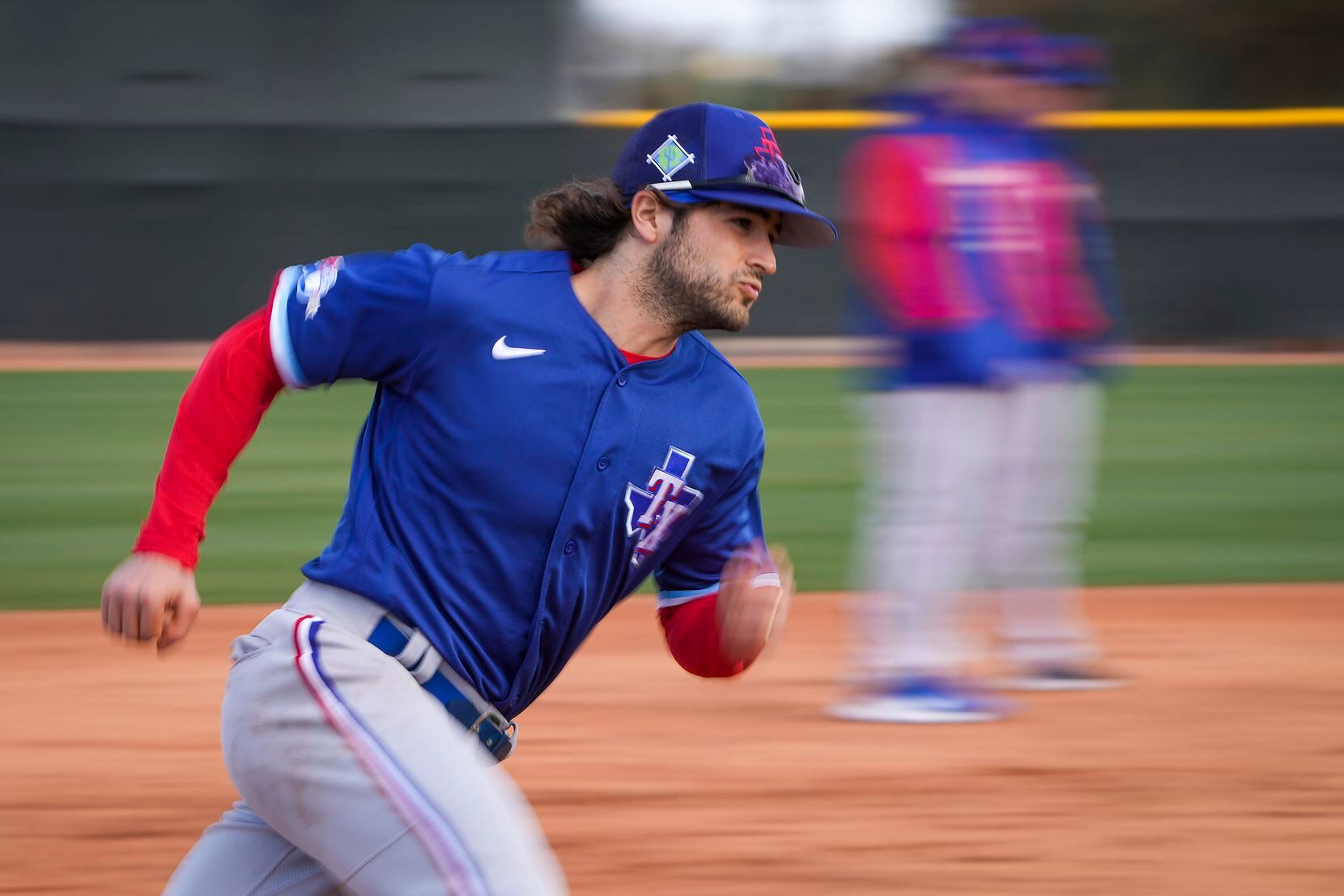 Infielder Josh Smith participates in a base running drill during a Texas Rangers minor...