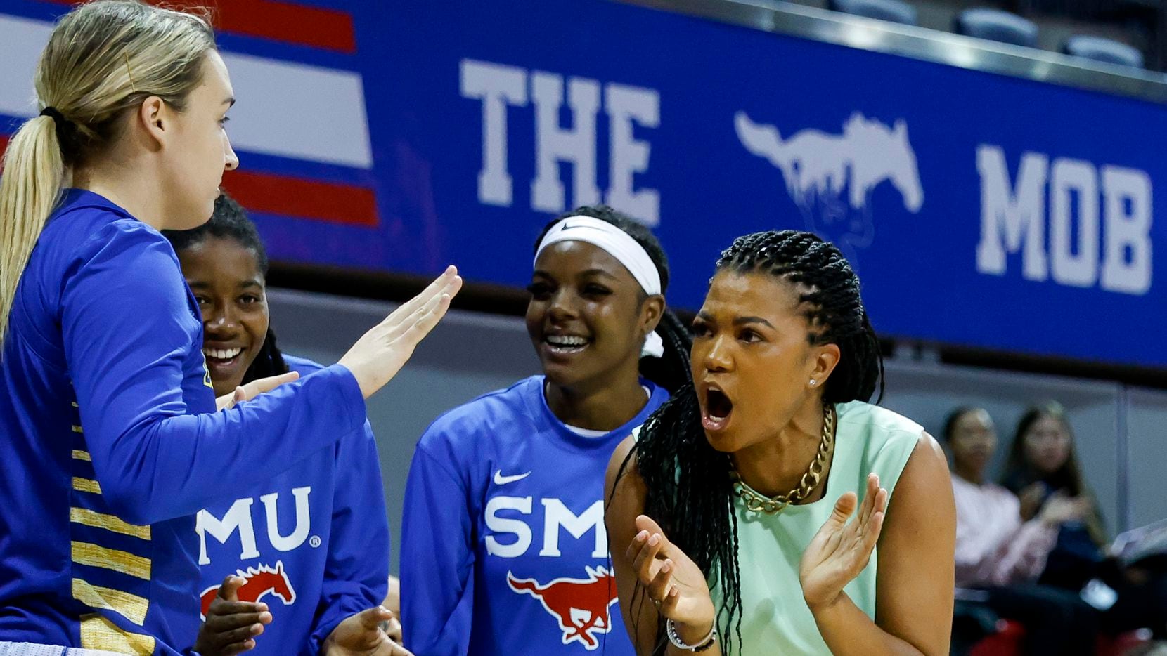 SMU head coach Toyelle Wilson cheers on the team during the first half of a game against...