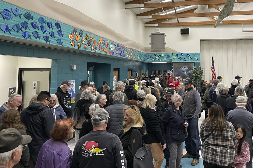 People wait for the caucus to begin at Spanish Springs Elementary School in Sparks, Nev.,...