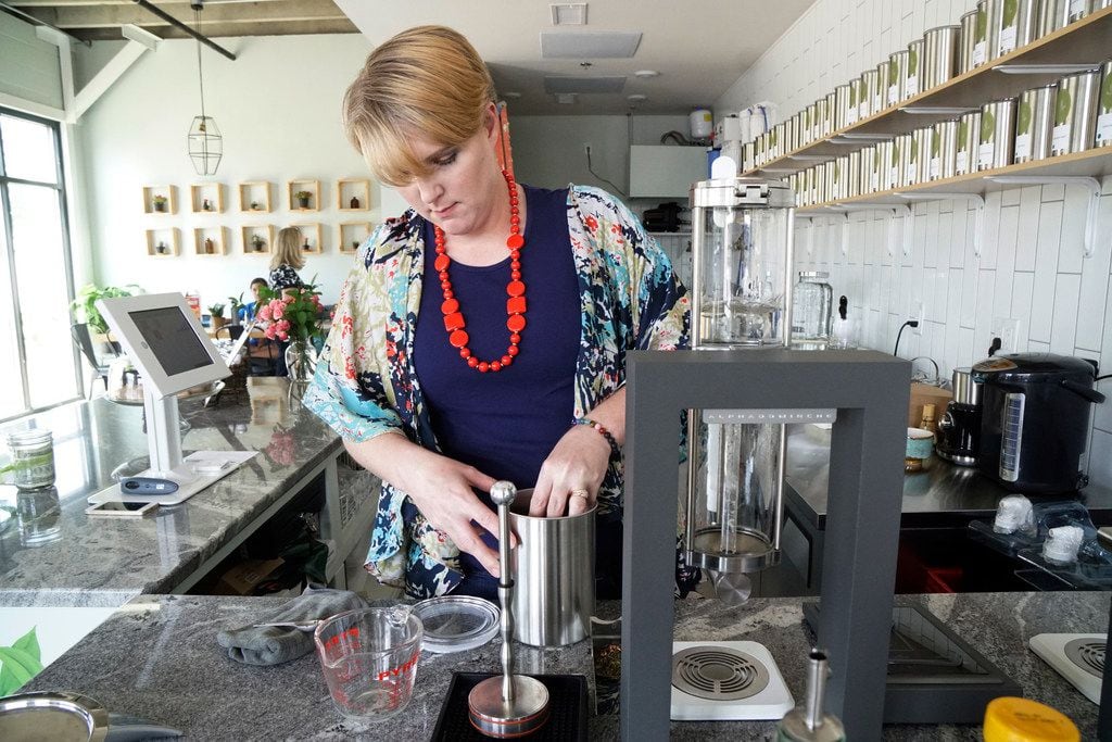 Tiffany Malkowski prepares a cup of tea at Leaves Book and Tea Shop in Fort Worth. 