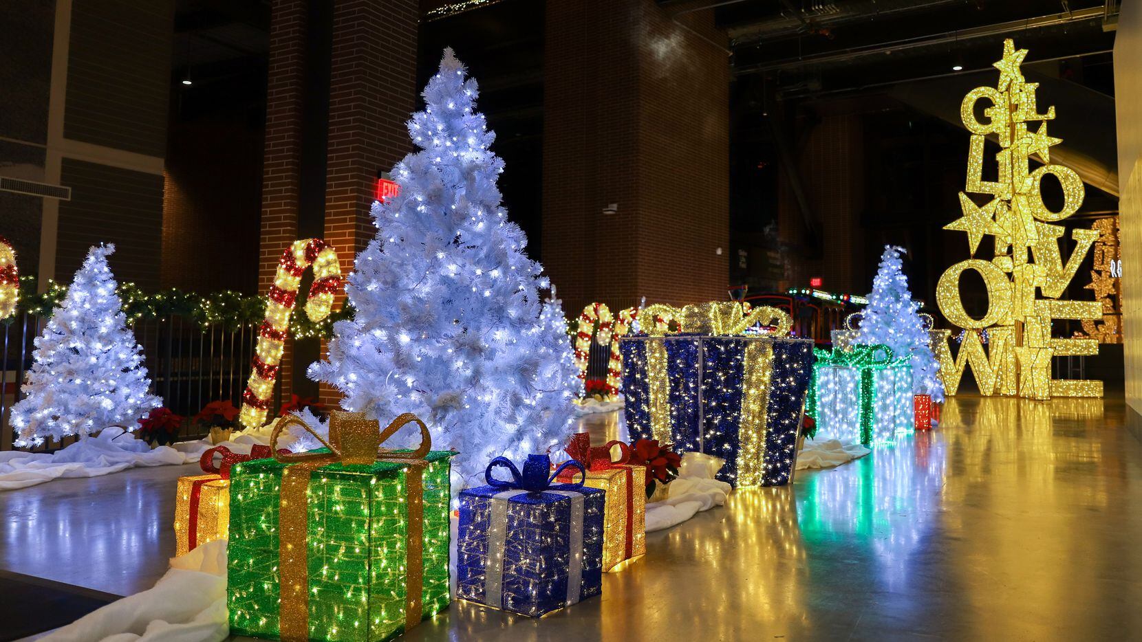 Christmas trees and large present shaped sculptures decorate the upper concourse at Luminova...