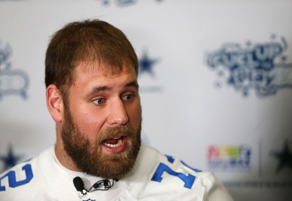 Cowboys center Travis Frederick talks with the media at Hillcrest High School in Dallas,...