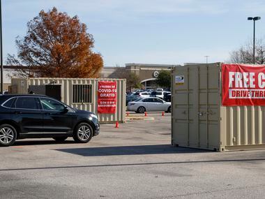 A car waits in line at a COVID-19 testing location in Richardson, Texas, on Dec. 24, 2021.