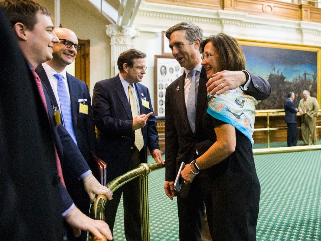 Sen. Van Taylor (center), author of the sunset bill, is congratulated by Sen. Lois Kolkhorst, Gov. Greg Abbott's Chief of Staff Daniel Hodge (left)  and others after the bill was passed during a midnight session of a special legislative session on Thursday at the Texas Capitol in Austin. 