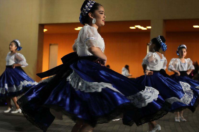 Members of Tenochtitlán Ballet Folklorico dance during the annual Posada at the Latino...