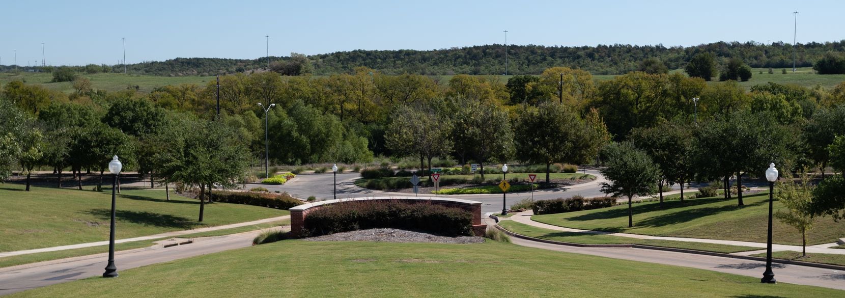 At the entrance to Capella Park in Dallas, off South Merrifield Road, traffic circles...