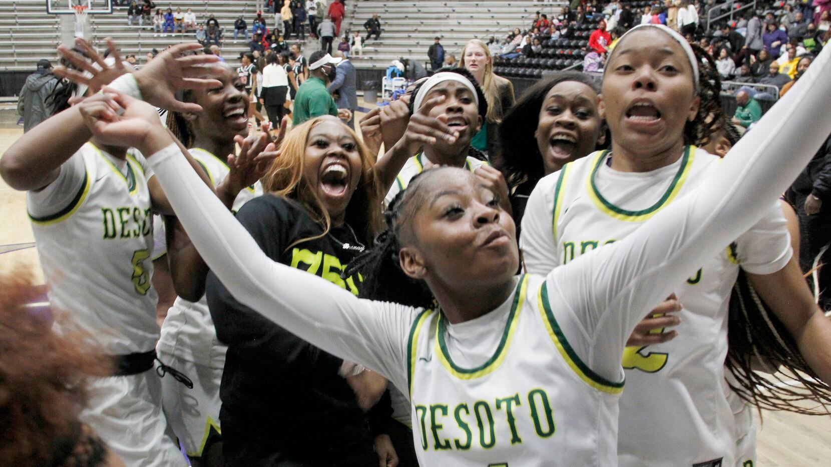 DeSoto guard Ja'Mia Harris (4) captures a video as she celebrates with teammates following...