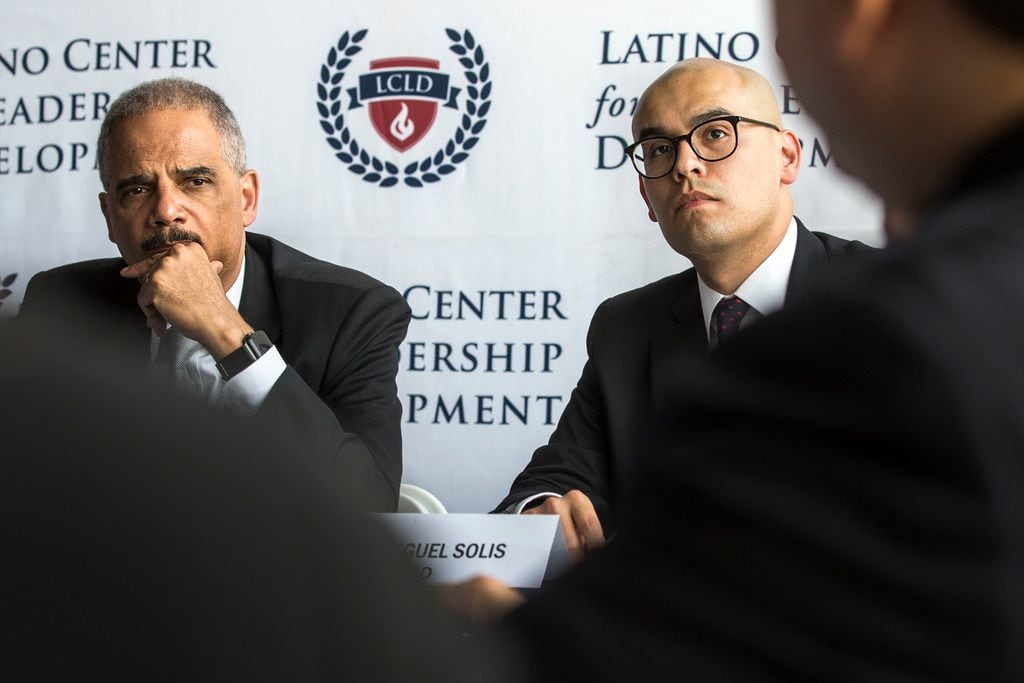 Former U.S. Attorney General Eric Holder (left) and Miguel Solis, president of the Latino...