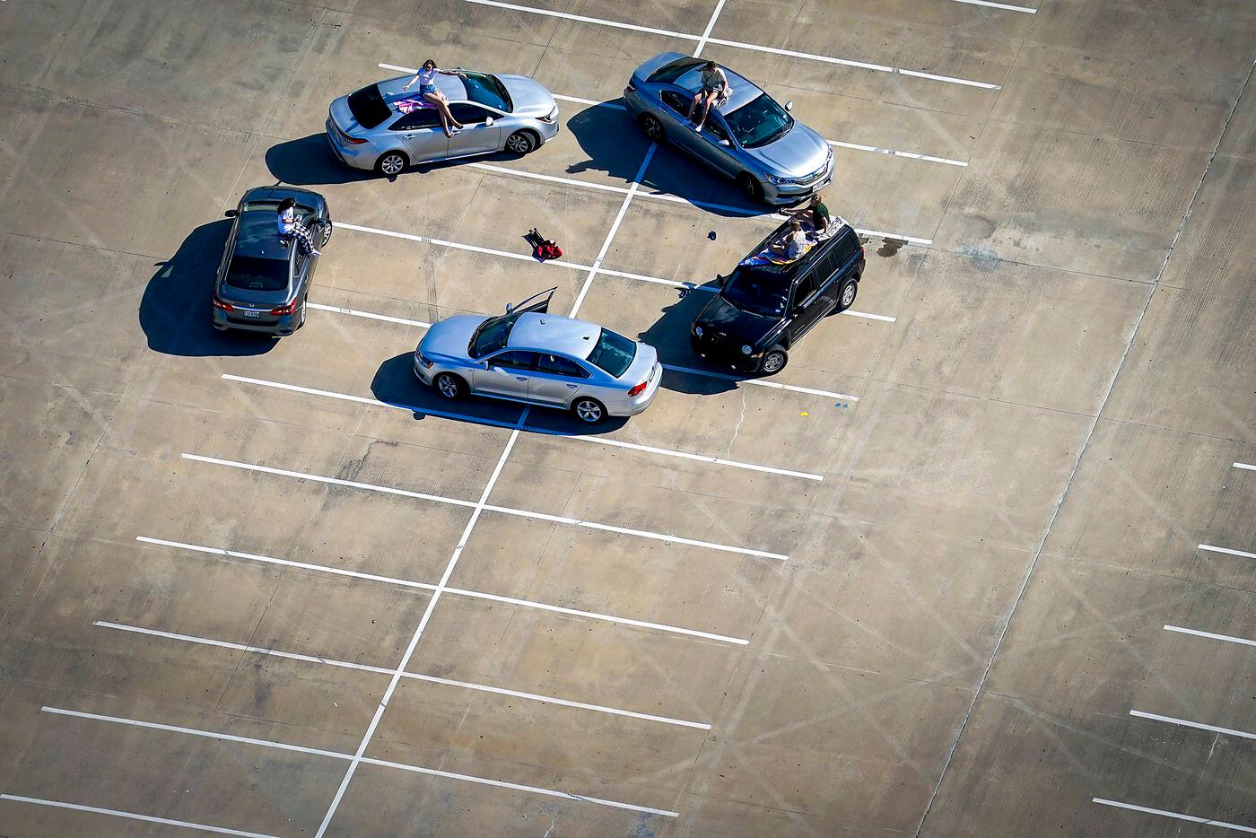 Young people gather in the parking lot of McKinney High School on Tuesday, March 24, 2020....