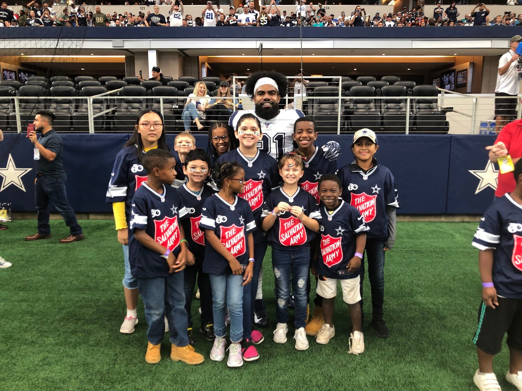 Dallas Cowboys running back Ezekiel Elliott took a moment out of his pregame warm-up routine last season to welcome youngsters from the Gene and Jerry Jones Family Youth Education Town at The Salvation Army Arlington to AT&T Stadium.