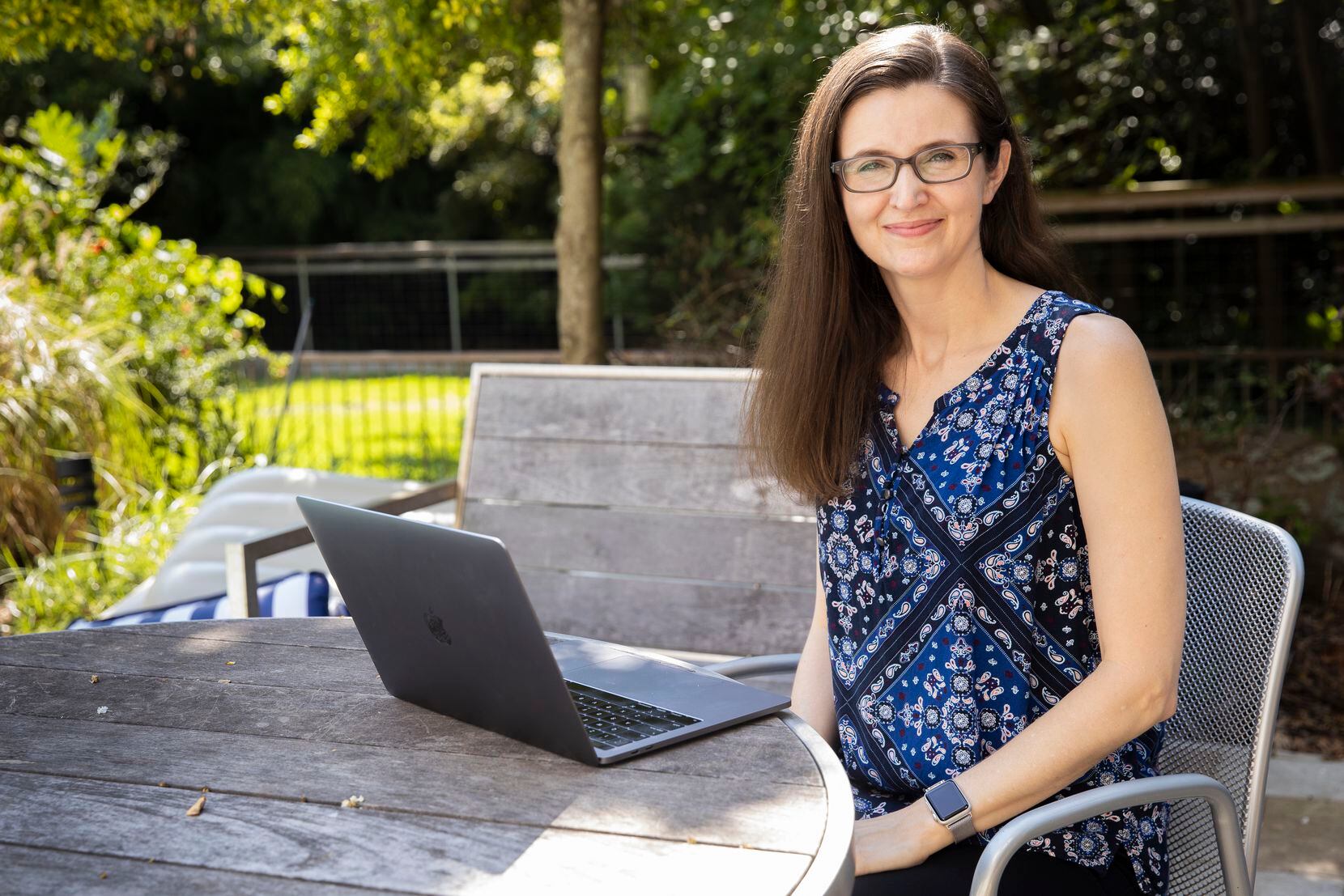 Candice Mills, a psychologist that studies how young children think, poses for a photo on her backyard patio where she sometimes works on Aug. 7, 2020 in Dallas, Texas. Mills normally conducts her studies in person but, due to COVID-19 restrictions, has shifted to working from home. (Juan Figueroa/ The Dallas Morning News)