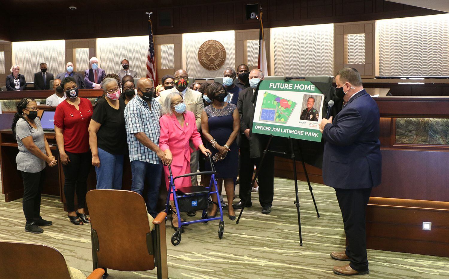 Mayor Bruce Archer presents plans for Jon Latimore park to the late police officer's family Tuesday at the Mesquite City Council meeting. Latimore was the city's first African American officer when he joined the force in 1985.