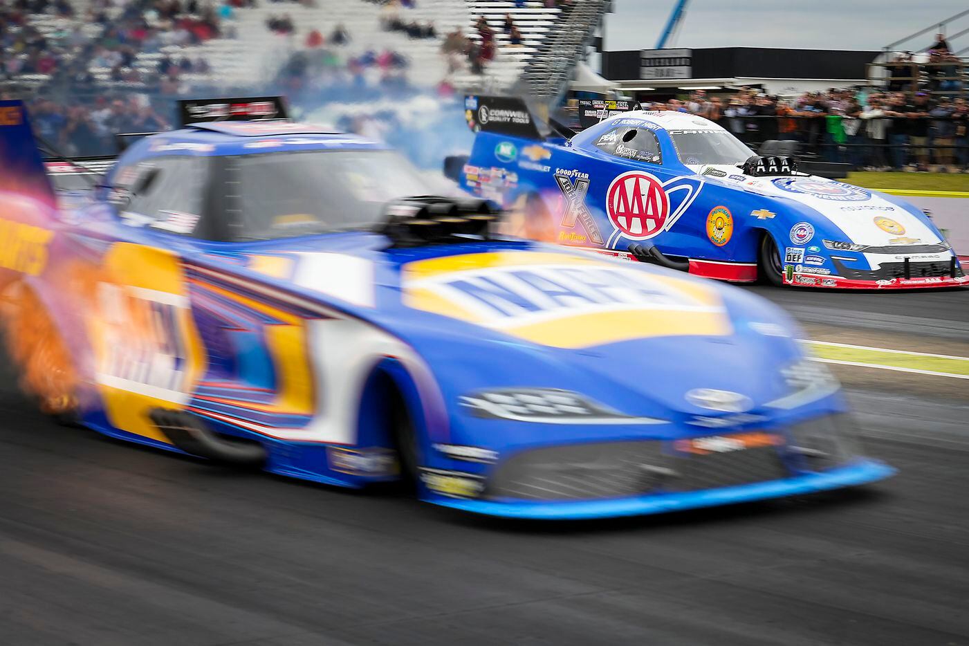 Ron Capps (front) beats Robert Hight off the line in a semifinal Funny Car victory at the...