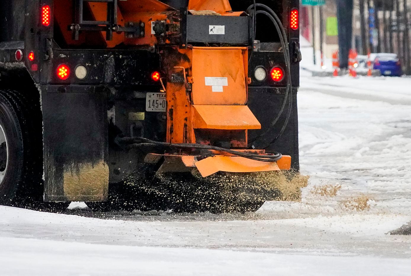 A City of Dallas truck spread sand on South Akard Street on Tuesday, Jan. 31, 2023, in...