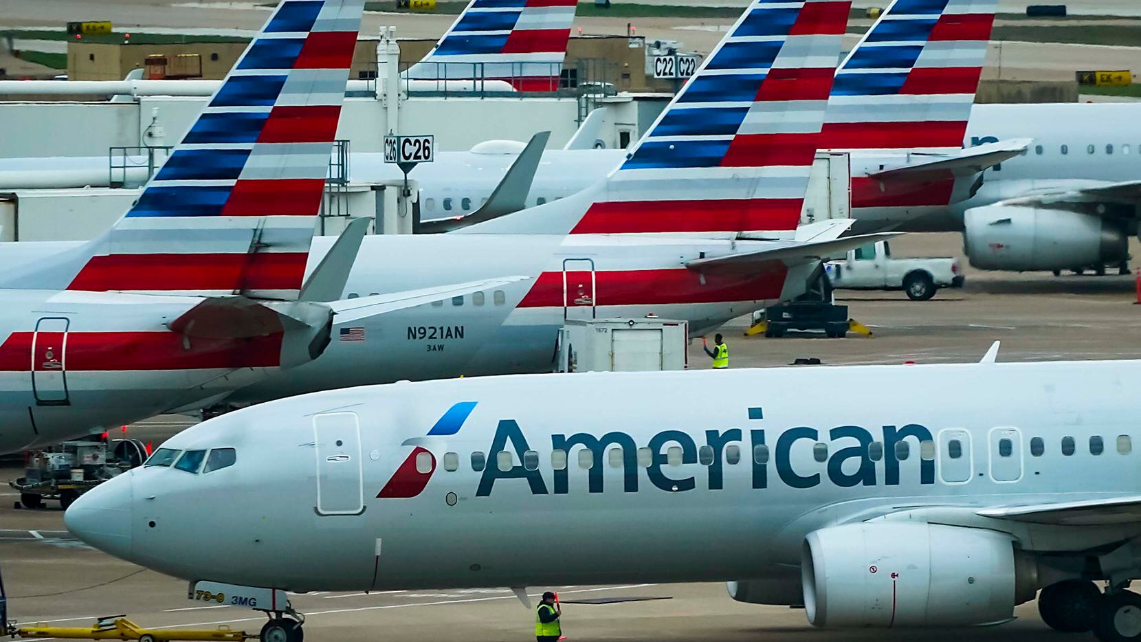 An American Airlines plane pushes back from the gate at Dallas Fort Worth International...