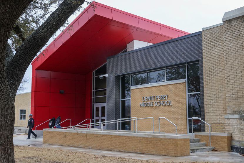 People enter and exit Carrollton-Farmers Branch ISD’s DeWitt Perry Middle School in...