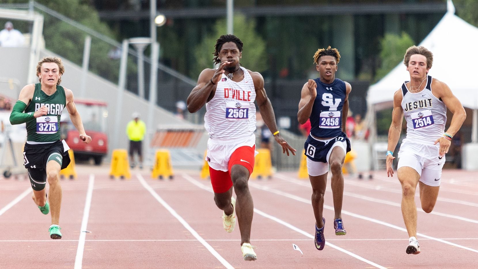 Duncanville's Pierre Goree (center, No. 2561) sprints to victory in the Class 6A 100 meters...