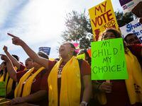 Demonstrators rally to show their support for expanding school choice options during...