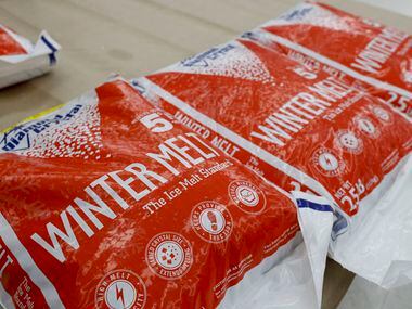Bags of ice melt sit on a pallet at Elliott’s Hardware in Dallas, Monday, Jan. 30, 2023....
