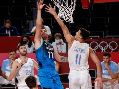 Slovenia’s Luka Doncic (77) shoots over Argentina’s Francisco Caffaro (11) in the second...