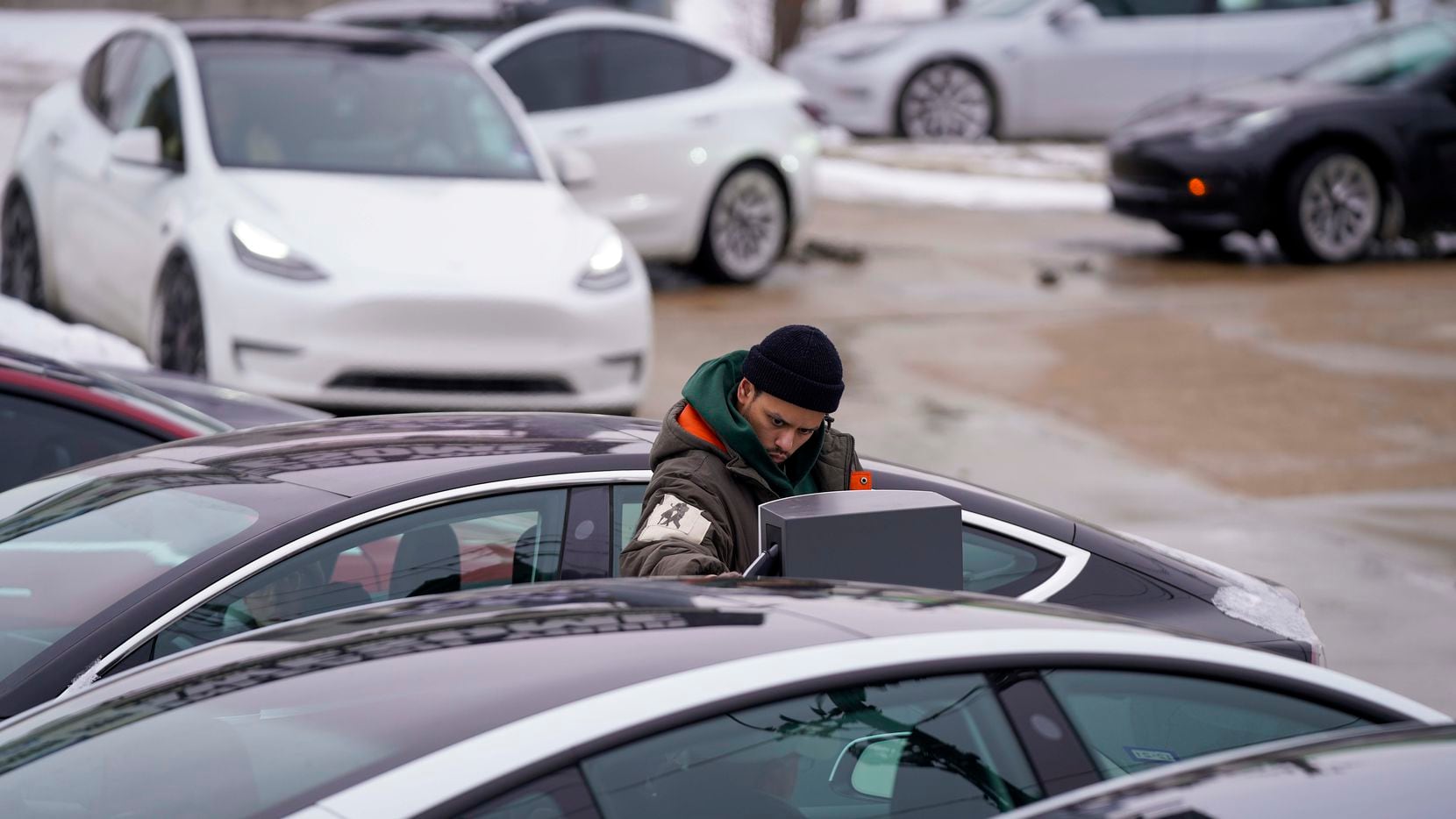 A line of cars waits for a charging station at the Tesla Supercharger on North Central Expressway near Walnut Hill on Tuesday, Feb. 16, 2021, in Dallas. More than 4 million Texans, many of them in North Texas, are fighting extended power outages. Another winter storm could dump 5 more inches of snow on Dallas-Fort Worth. (Smiley N. Pool/The Dallas Morning News)