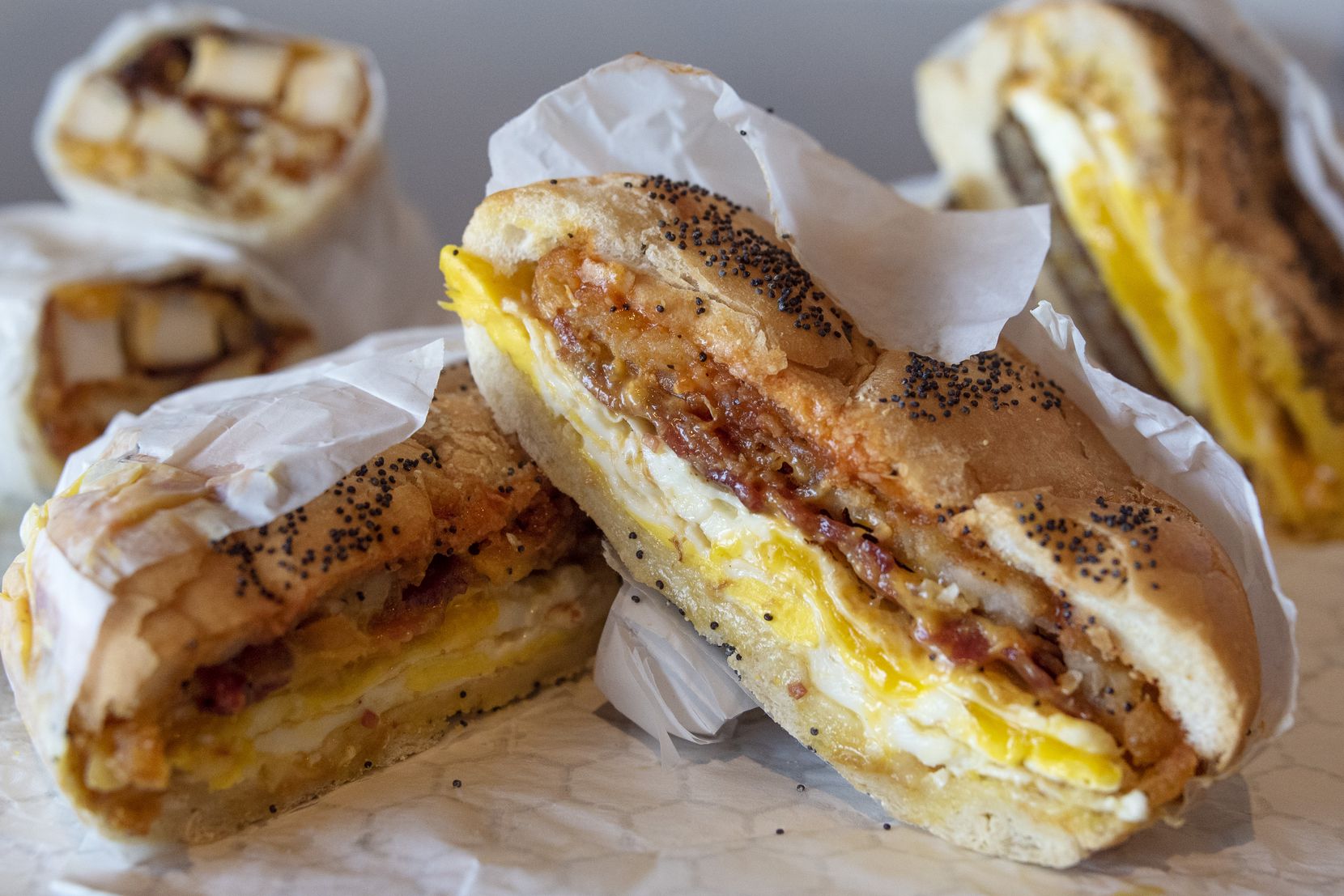 The Shug is a breakfast sandwich made with with bacon, egg, cheese and a hash brown on a...