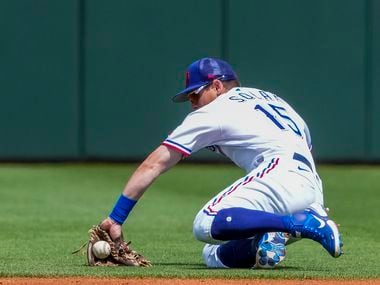 Texas Rangers second baseman Nick Solak makes a play on a grounder behind the bag during the...