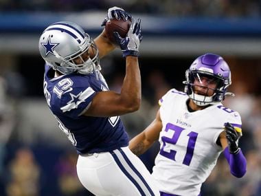 FILE - Cowboys wide receiver Amari Cooper (19) catches a pass in front of Vikings cornerback Mike Hughes (21) during the first half of play at AT&T Stadium in Arlington on Sunday, Nov. 10, 2019.