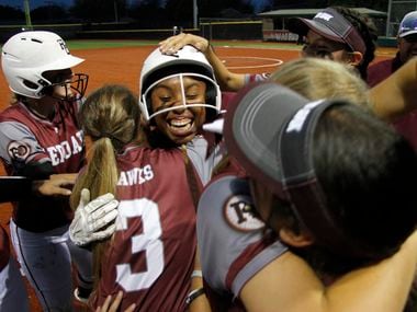 Brianna Evans (center) is mobbed by teammates after her walk-off run-scoring hit in the bottom of the seventh gave Red Oak an 8-7 win over North Forney in Game 1 of a best-of-3 Class 5A bi-district playoff series. (Steve Hamm/Special Contributor)