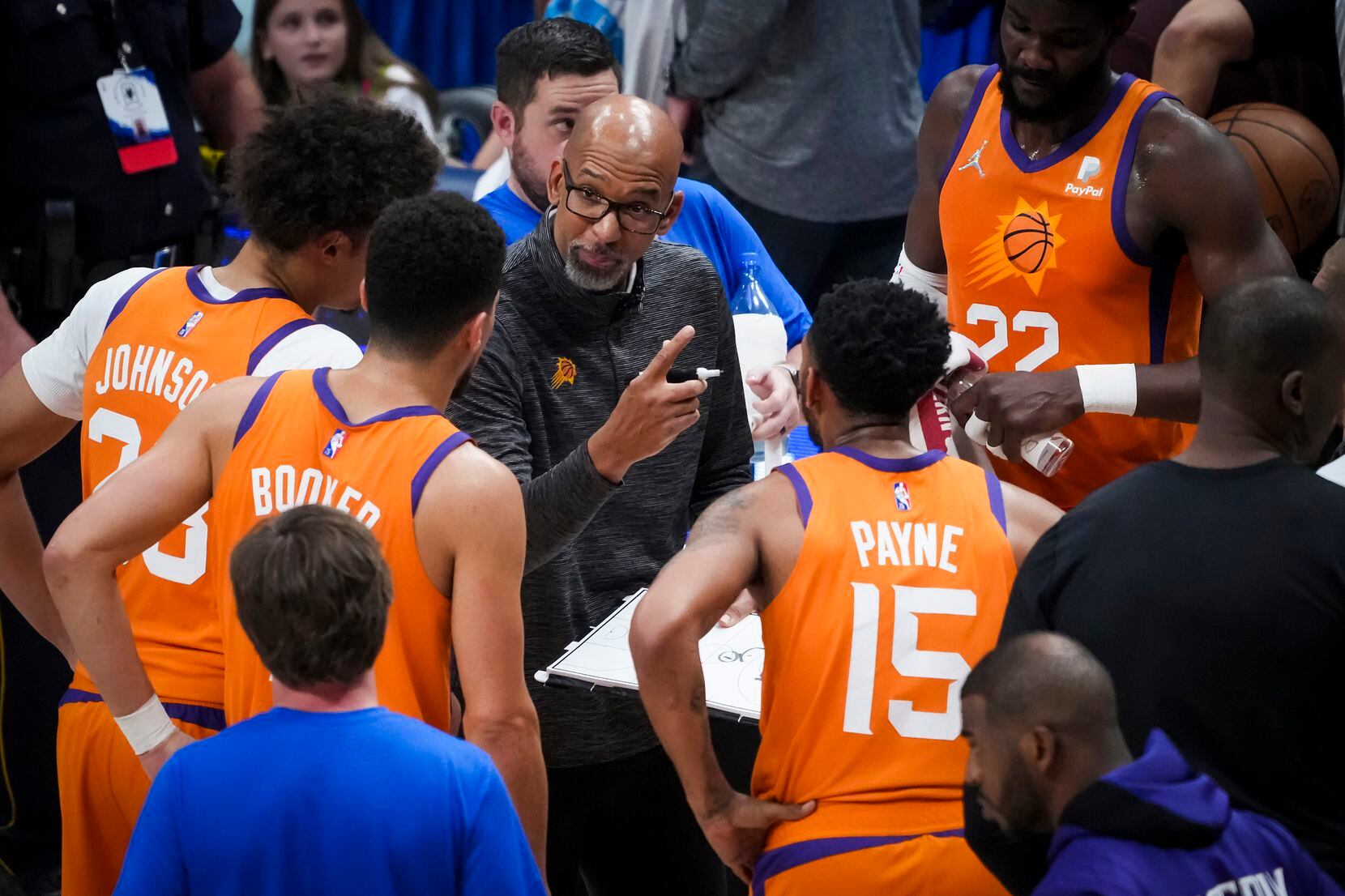 Phoenix Suns head coach Monty Williams huddles with forward Cameron Johnson (23), guard...
