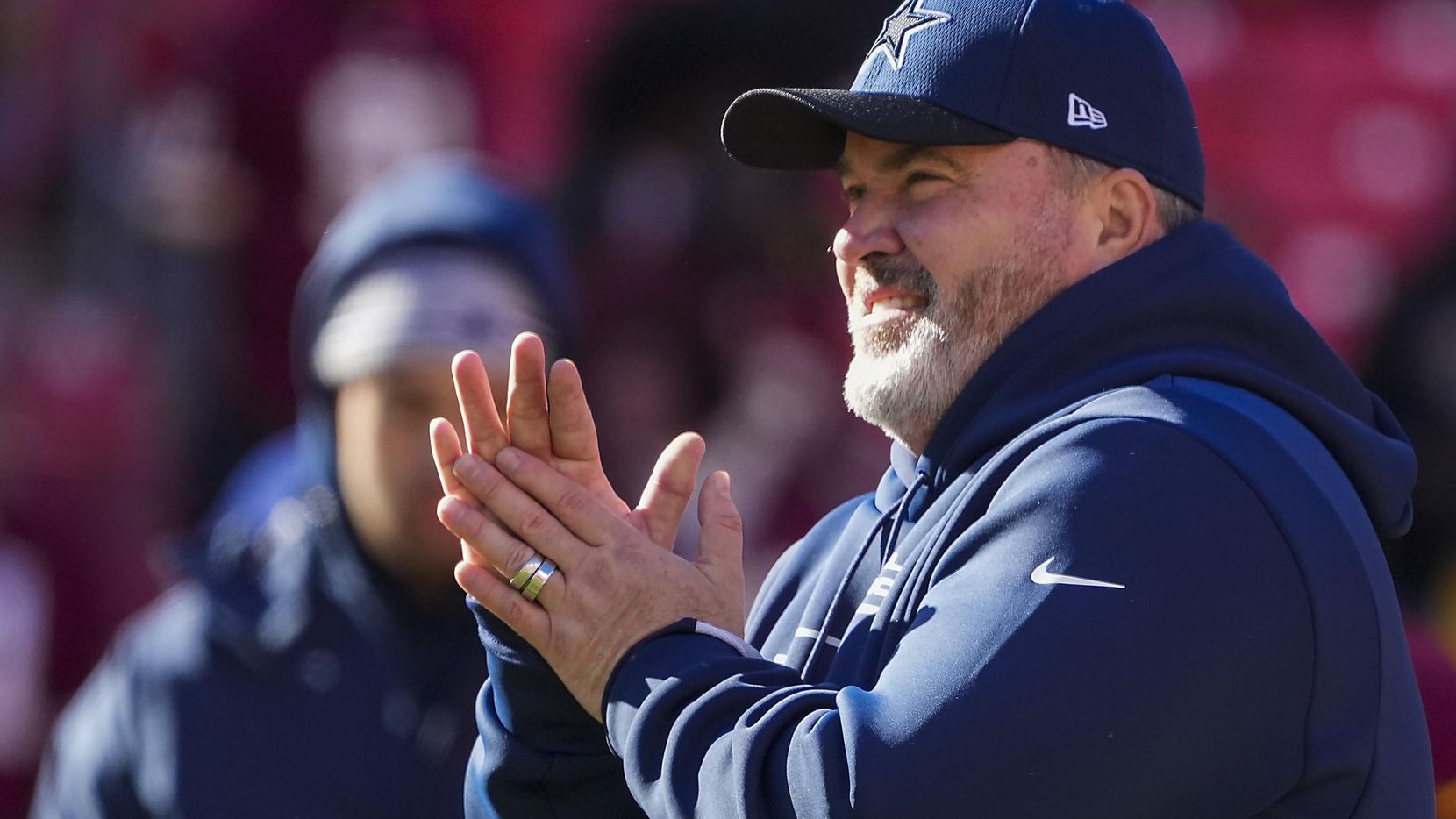 Dallas Cowboys head coach Mike McCarthy watches the teams warm up before an NFL football game against the Washington Football Team on Sunday, Dec. 12, 2021, in Landover, Md.