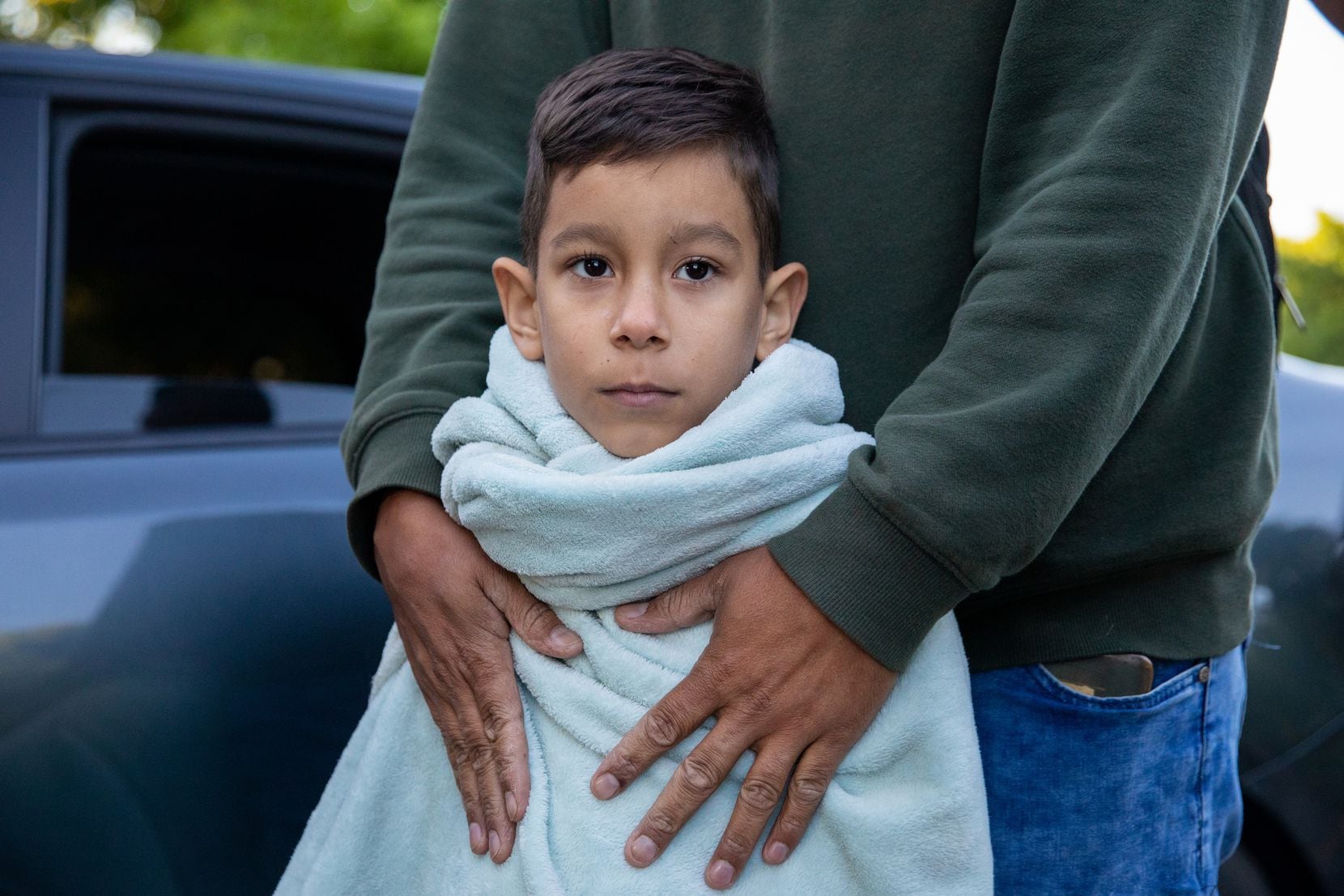 Abraham Granadillo, on his sixth birthday, stood in his father’s arms after they arrived on...