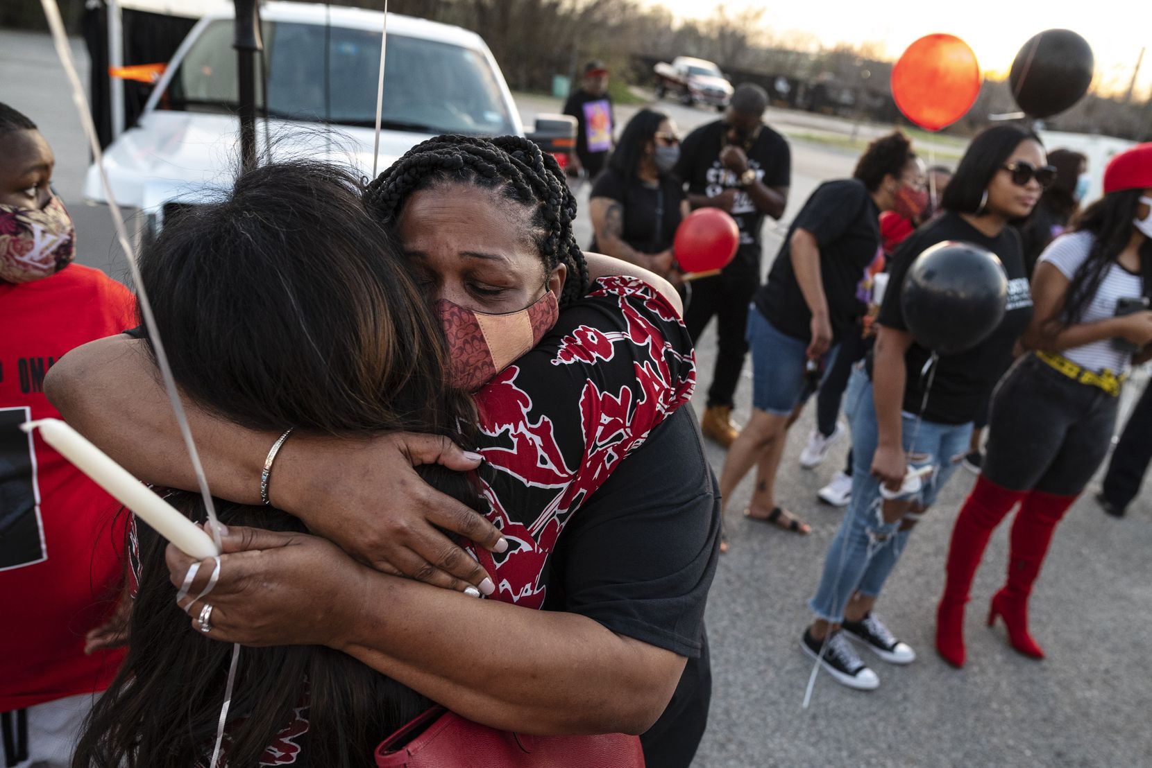 Candace Fleming (right) was hugged by friend Karith Foster as they mourned the death of...