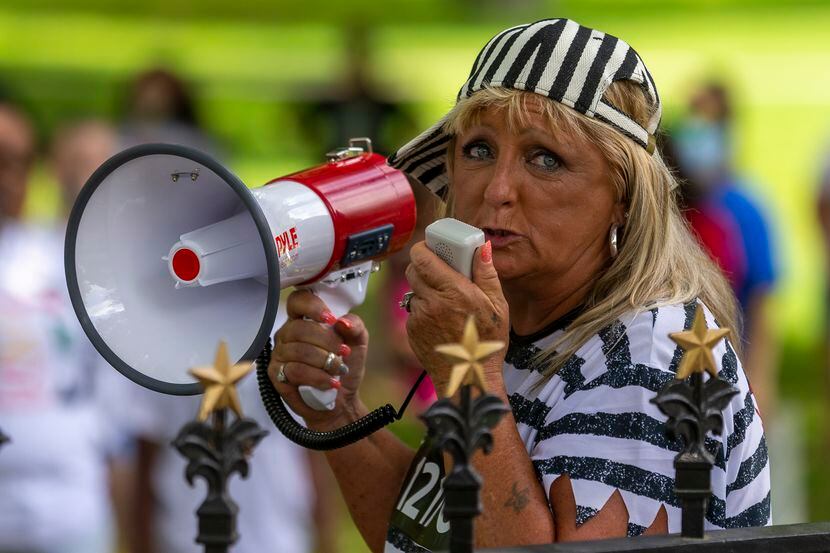 Tina Carraway, of Marlin, speaks during a rally with other family members of people...